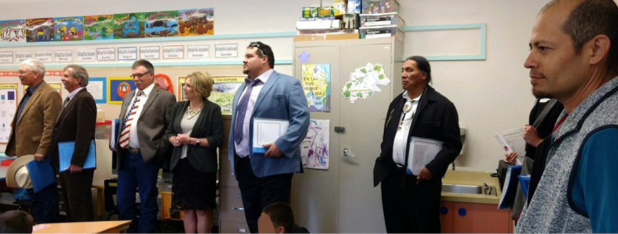 STRC members and OPI staff observe a language immersion classroom at Crow Agency Elementary with Principal Jason Cummins.